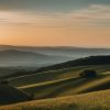 Photographer capturing landscape in a serene, natural setting, away from city life.